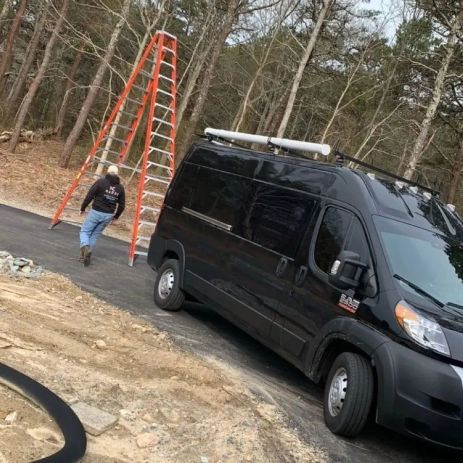 Zach Nardi loading his service van on a job site
