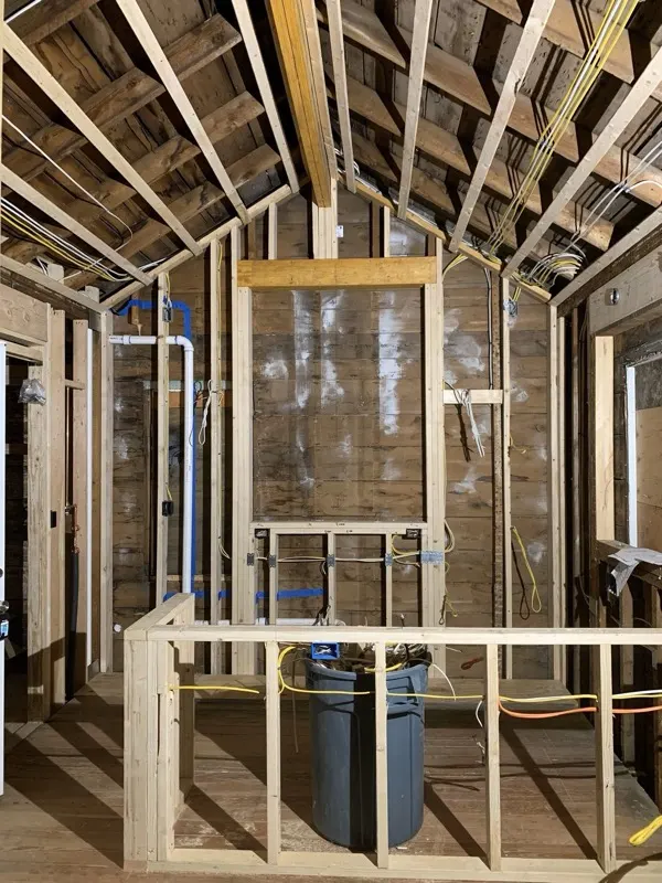 New wiring run through open ceiling framing during a remodel