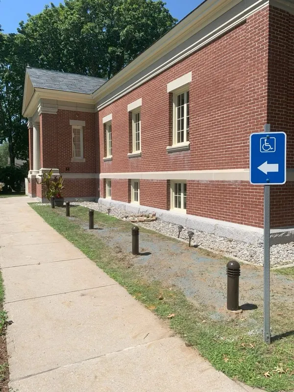 Commercial brick building with landscape bollard lighting, daytime