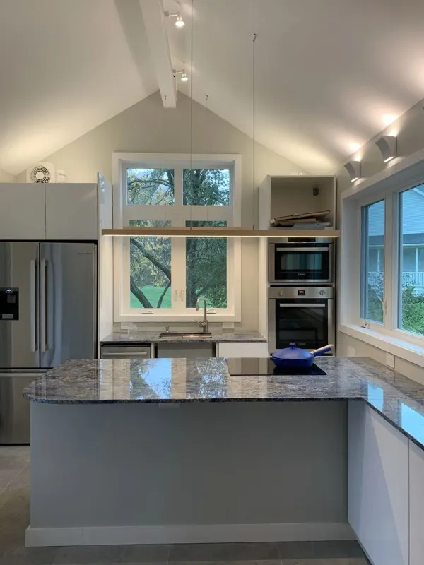 Vaulted kitchen with recessed and pendant lighting