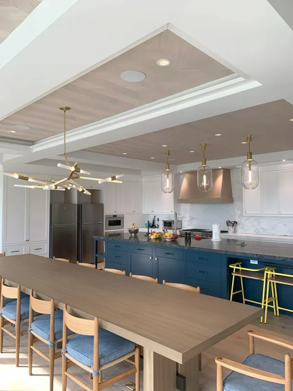 Finished kitchen with brass pendant lighting and chandelier