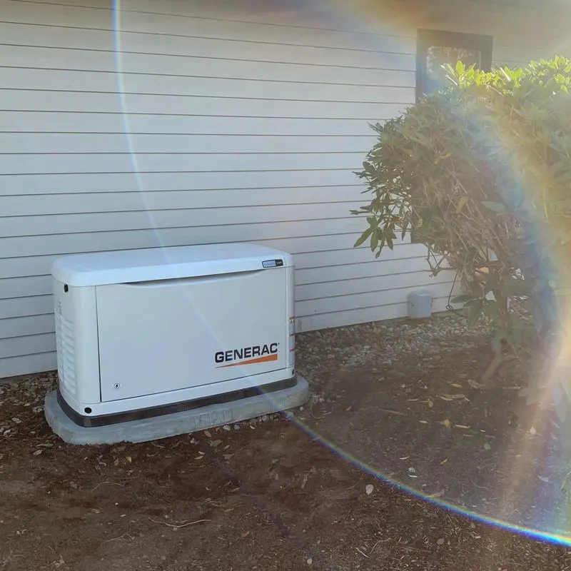 Generac standby generator installed beside a home, golden hour
